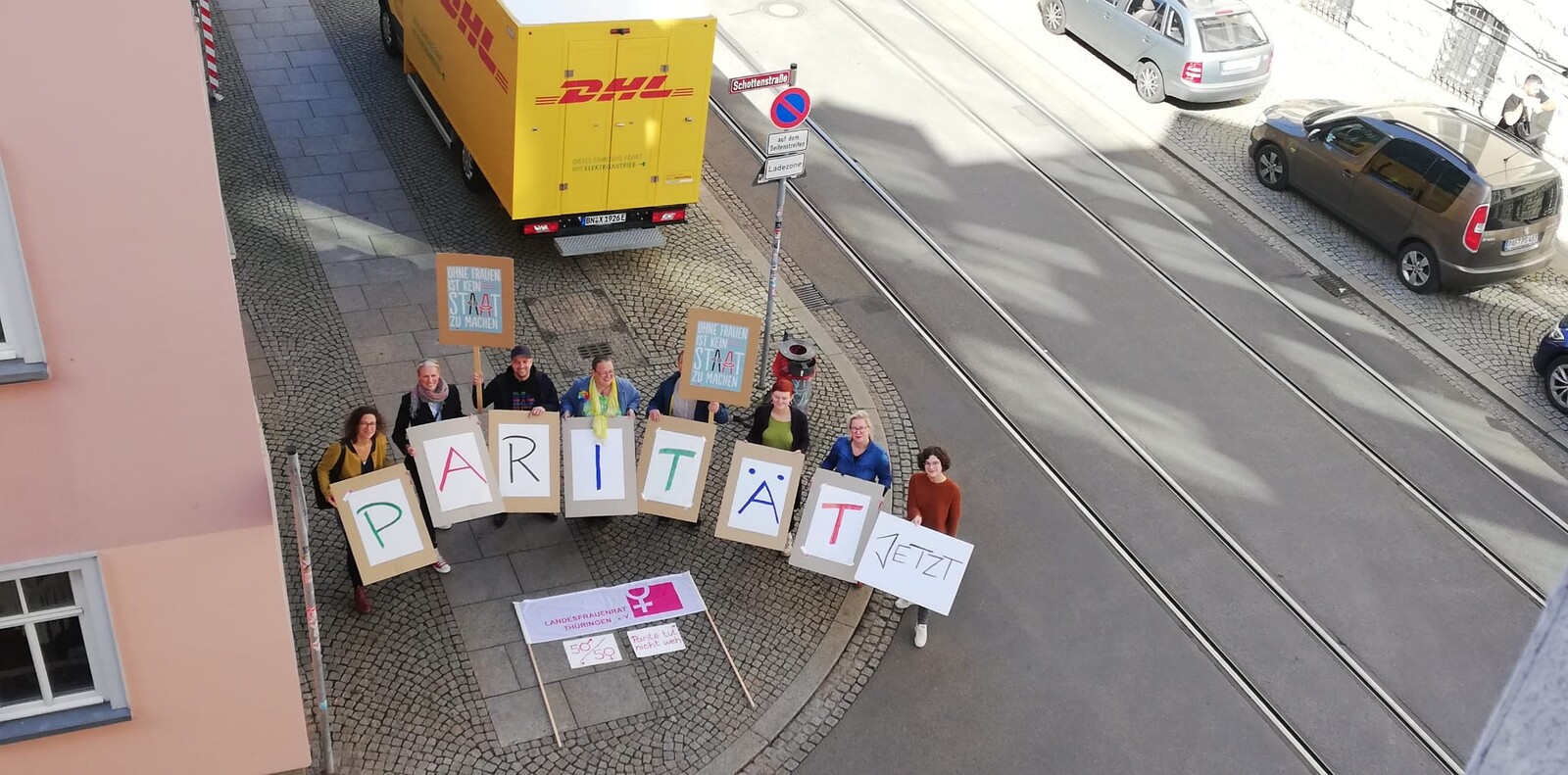 Aktion des Landesfrauenrats Thüringen auf der Johannesstraße in Erfurt. Personen halten Schilder in die Luft mit der Aufschrift "Parität Jetzt", "Ohne Frauen ist kein Staat zu machen"